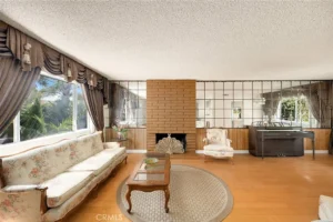 living room with a vintage style features a floral couch and armchair.