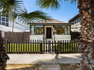 real estate white house with a dark picket fence
