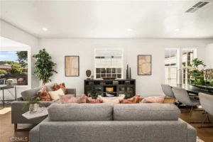 living room with gray sofas pink and patterned pillows