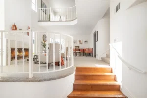 living room with a curved staircase and wooden steps