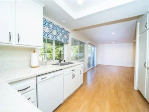 modern kitchen with white cabinets, stainless steel sink, and dishwasher