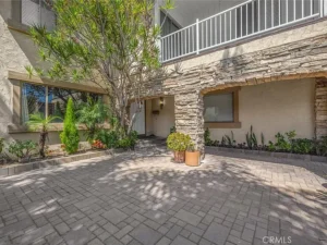 Courtyard with stone archway and potted plants