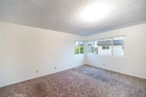 Empty room with white walls and a textured ceiling