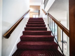 Red carpeted stairs with white polka dots