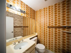 bathroom with bold orange and brown geometric wallpaper