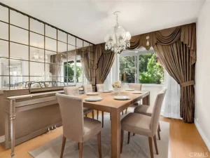 Elegant dining room with a wooden table set for six.